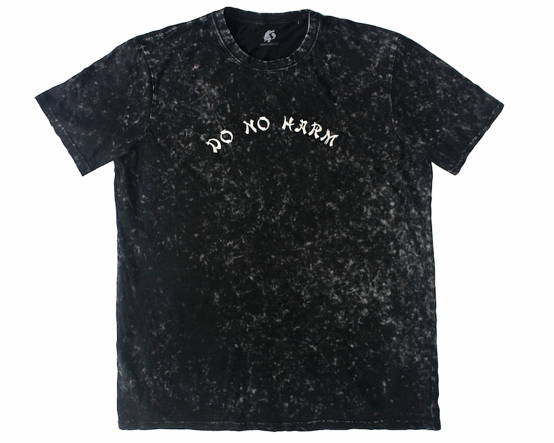 May include: Black t-shirt with a white "Do No Harm" inscription in a stylized font. The shirt has a distressed, acid-washed look.
