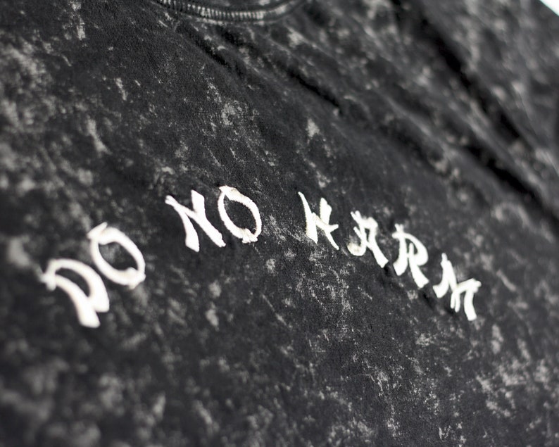 May include: Black t-shirt with a white distressed graphic that says "DO NO HARM".