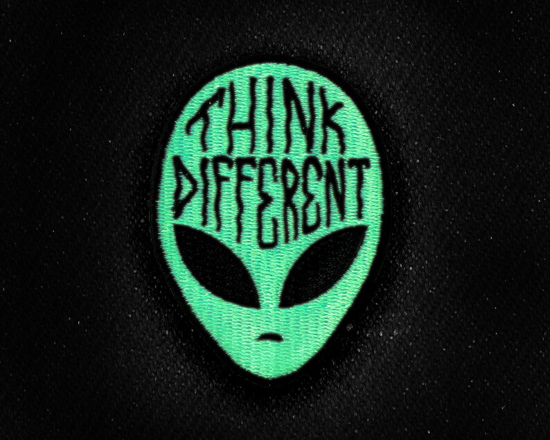 May include: Green alien head patch with the text "Think Different" in black.