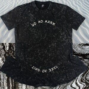 May include: Black t-shirt with a white distressed print that says "Do No Harm" and "Take On The Sky".