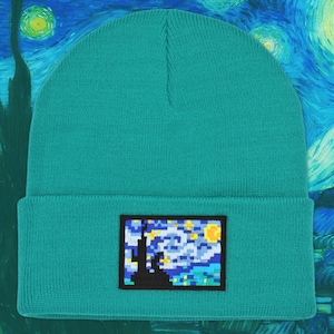 May include: Teal blue knitted beanie with a pixelated image of Van Gogh's Starry Night.
