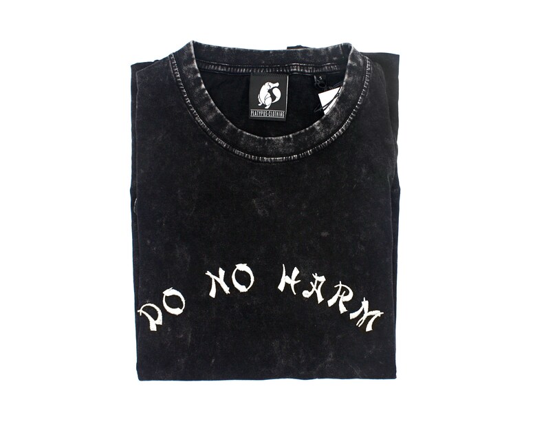 May include: Black t-shirt with a white "Do No Harm" graphic printed on the front. The shirt has a distressed, vintage look.