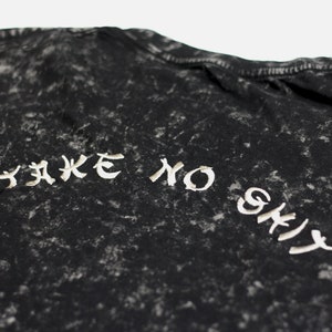 May include: Black t-shirt with a white distressed graphic that says "Take No Shit".