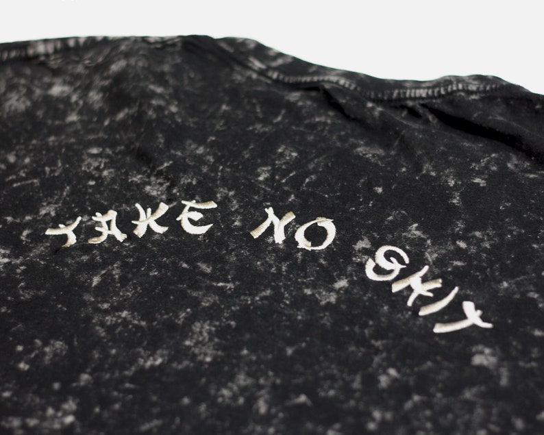 May include: Black t-shirt with a white distressed graphic that says "Take No Shit".
