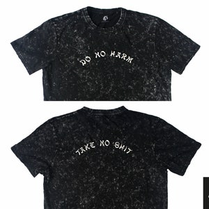 May include: Black t-shirt with a distressed, speckled look. The front of the shirt says "Do No Harm" in white lettering. The back of the shirt says "Take No Shit" in white lettering.