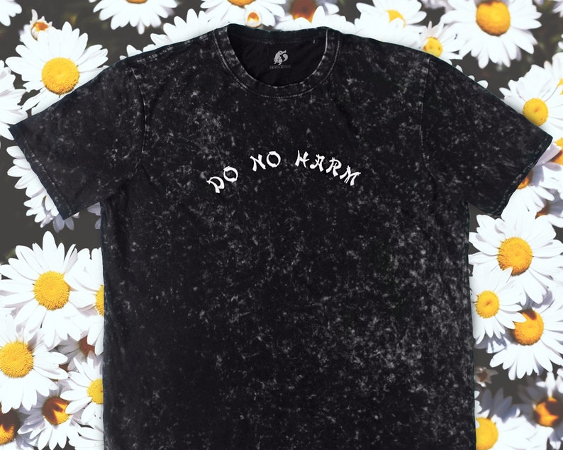 May include: Black t-shirt with a white distressed print that says "Do No Harm" on a black background.