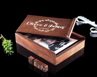 May include: A wooden box with a lid engraved with "Olivia & James" and the date "12.08.2020". The box is open and contains a photograph and a small wooden USB drive engraved with "O & J".