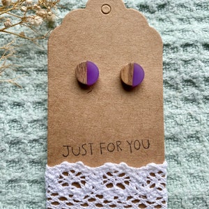 May include: A pair of purple and wood earrings on a brown card with the text "JUST FOR YOU" and white lace trim.