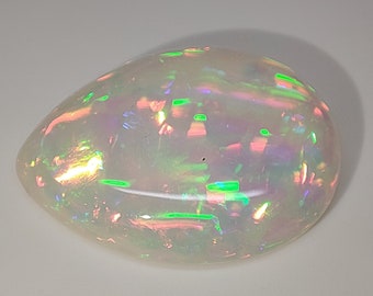 May include: A white opal gemstone with iridescent flashes of green, pink, and blue.