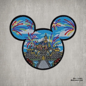 May include: An embroidered patch shaped like Mickey Mouse's head, featuring a colorful depiction of Cinderella's Castle with fireworks in the sky.