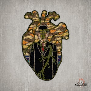 May include: Embroidered patch featuring a stylized human heart with a man in a black suit and a green vine growing through him. The heart is surrounded by a colorful, abstract pattern.