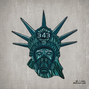 May include: A blue and green embroidered patch depicting the Statue of Liberty wearing a gas mask. The patch features the text "NEVER FORGET 911" and the number "343".
