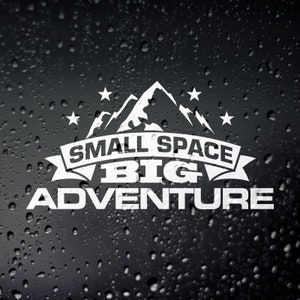 May include: White vinyl decal with a mountain range graphic and the text "Small Space Big Adventure".