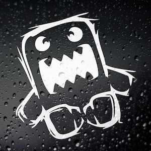 May include: White vinyl sticker of a cartoon monster with a big mouth and large eyes. The monster is in a playful pose with its arms outstretched. The sticker is on a dark background.
