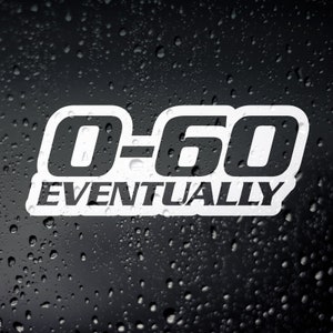 May include: White sticker with the text "0-60 EVENTUALLY" in a bold, blocky font. The sticker is on a black background with water droplets, creating a wet effect. The text is outlined in black.