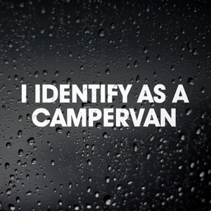 May include: A white sticker on a black background with raindrops. The sticker says "I identify as a campervan."