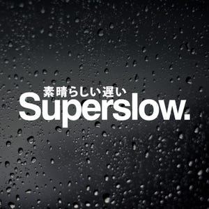 May include: A black background covered in water droplets, with white text reading "Superslow." and Japanese text above. The image has a dark, atmospheric feel.