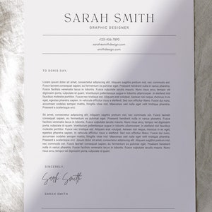 May include: A resume template with the name "SARAH SMITH" and the title "GRAPHIC DESIGNER" is displayed on a white paper. The text "Resume + Cover Letter Builder" is at the top. The bottom of the page says "Easily edit in CANVA".