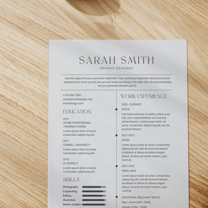 May include: A resume template for a graphic designer, featuring the name "SARAH SMITH" in a clean, modern font. The document includes sections for education, work experience, and skills, with a summary statement at the top. A small vase with greenery sits at the top.