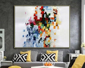 May include: A living room with a gray couch, a white coffee table, a black chair, and a large abstract painting with colorful squares on a white background. The room has a black and white patterned rug.