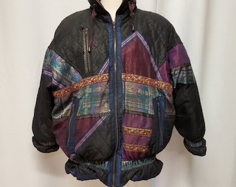 May include: A vintage black puffer jacket with a quilted design. The jacket features colourful patchwork panels in shades of purple, teal, and burgundy, accented with decorative trim. It has a zip-up front, a high collar, and elastic cuffs.