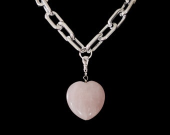 Hand holding a heart shaped pink quartz chain necklace pendant charm loop goth rock gift wicca gemstone love jewelry love rock gift pagan