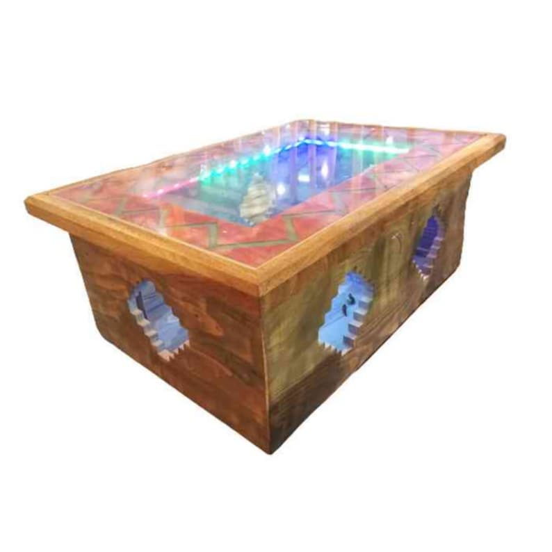 Op de afbeelding: Een houten salontafel met een glazen blad en een kleurrijke LED-lichtweergave eronder. De tafel heeft een uniek ontwerp met uitsparingen aan de zijkanten, waardoor de lichtweergave zichtbaar is.