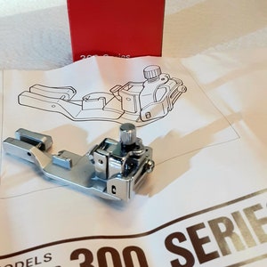 Bernina Bernette 300 series sewing machine Elasticator attachment foot. Pre owned in Very good condition.