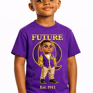 May include: A purple t-shirt with the word "FUTURE" in gold lettering. The shirt features a cartoon illustration of a young boy wearing a yellow and purple jacket. The text "Est. 1911" is below the illustration.