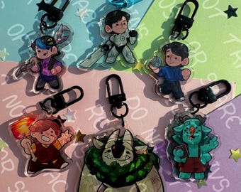 May include: Collection of acrylic character keychains with black metal clasps. The keychains feature various cartoon characters in different poses, with vibrant colors and detailed designs. Some characters hold weapons or objects, and the background includes text and star-shaped confetti.