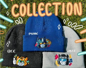May include: A collection of three beanies with embroidered cartoon robot designs. The beanies are in blue, gray, and black. The blue beanie says "PRIME" and the black beanie says "BEE". The text "AUTOBOT COLLECTION" is at the top.