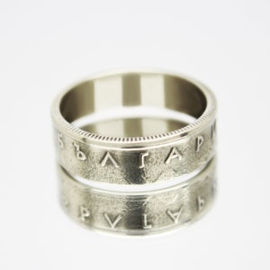 May include: A silver ring made from a coin with the word "BULGARIA" inscribed around the band.