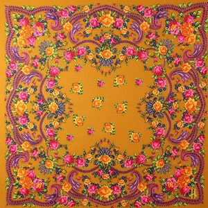 May include: A square, mustard yellow fabric with a floral pattern. The pattern features pink, yellow, and orange flowers with green leaves. The fabric has a paisley design with a dark blue outline.