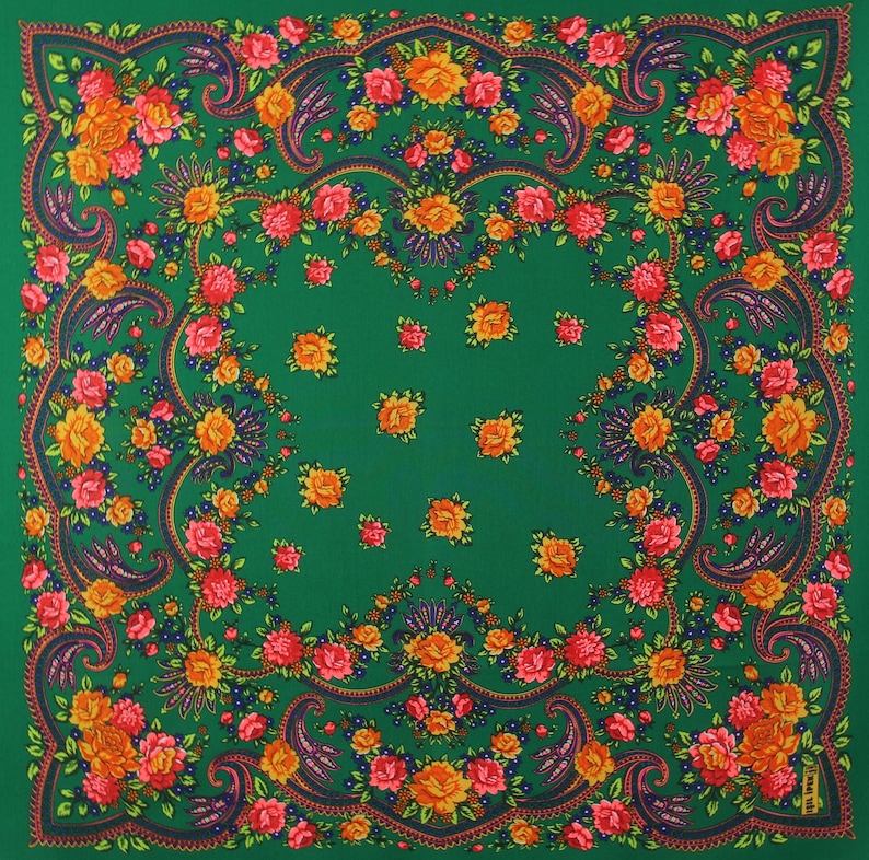 May include: A green square scarf with a paisley pattern and floral designs in shades of red, orange, and yellow.