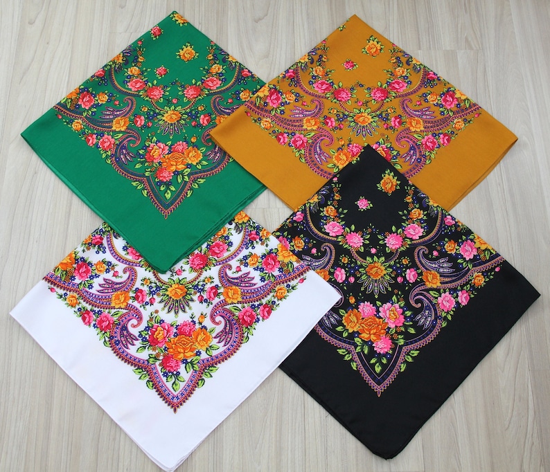May include: Four square patterned scarves in different colors: green, yellow, black, and white. Each scarf features a floral design with pink, orange, and purple flowers.