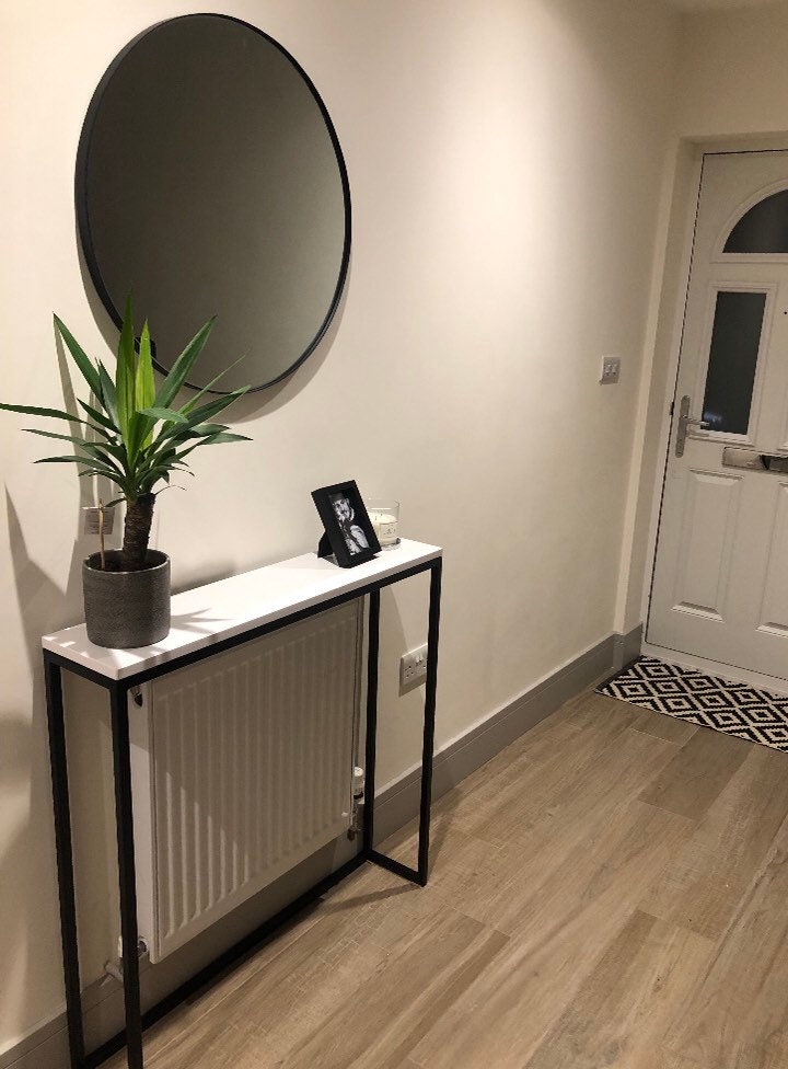 White console outlet table over radiator
