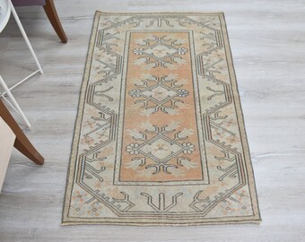 May include: A vintage runner rug with a beige background and an intricate geometric pattern in shades of peach and brown.