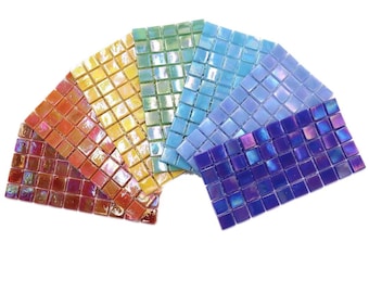 May include: A set of six iridescent mosaic tiles in various colors, including red, orange, yellow, green, blue, and purple. The tiles are arranged in a fan shape.