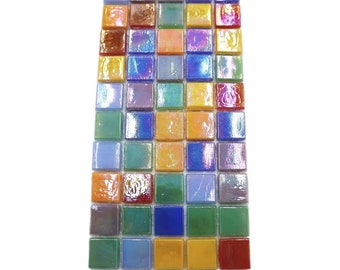 May include: A sheet of iridescent glass mosaic tiles in various colors, including blue, green, yellow, orange, and red. The tiles are arranged in a grid pattern.