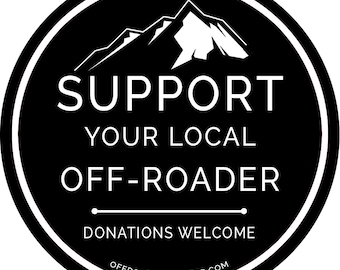 May include: Black and white circular sticker with a mountain silhouette and the text "SUPPORT YOUR LOCAL OFF-ROADER" with a line below and the text "DONATIONS WELCOME" below the line. The text "OFFROAD-OUTFITTER.COM" is at the bottom of the sticker.