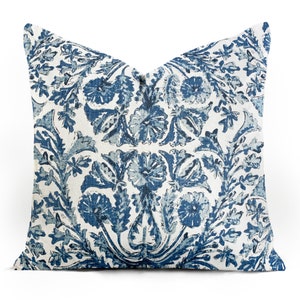 May include: A blue and white patterned throw pillow with a floral design.