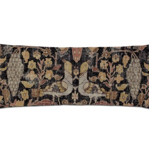 May include: A long rectangular pillow with a black background and a colorful floral pattern. The pattern features birds, flowers, and vines in shades of brown, beige, and pink.