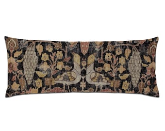 May include: A long rectangular cushion with a black background and a colourful floral pattern. The pattern features birds, flowers, and vines in shades of brown, beige, and pink.