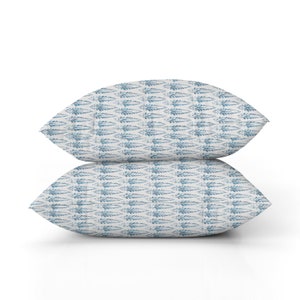 May include: Two throw pillows with a blue and white fern pattern.