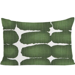 May include: A green and white rectangular cushion with an abstract pattern of green shapes on a white background.