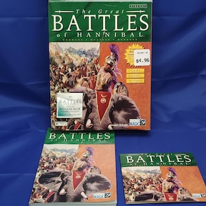 May include: A collection of computer game boxes and manuals for "The Great Battles of Hannibal." The boxes feature illustrations of soldiers, elephants, and battle scenes. The main box has a green top and a price tag.