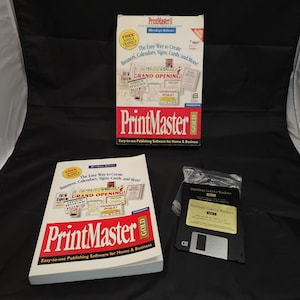 May include: A PrintMaster Gold software package, including a box, a manual, and floppy disks. The box is red, white, and gold, with the text "PrintMaster" and "Easy-to-use Publishing Software for Home & Business."