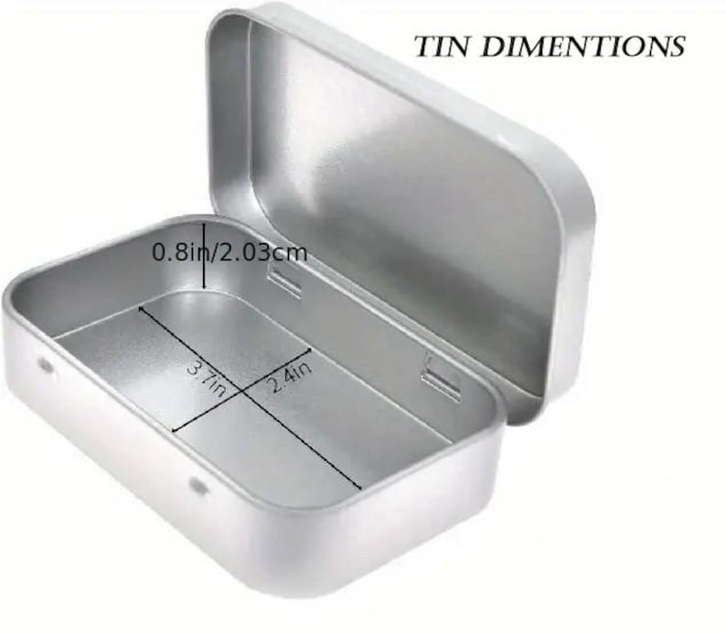May include: A silver metal rectangular tin with a hinged lid. The tin measures 9.4 cm by 6.1 cm and is 2.0 cm deep.