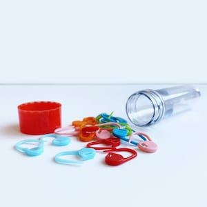 Stitch Markers with a twist top storage tube, Stitch markers with case, stitch markers for knitting, knitting notions, New in packaging.