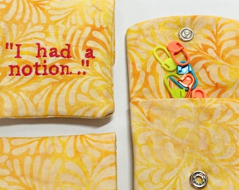 Handmade notion Pouch, embroidered with the phrase I had a notion on yellow batik fabric